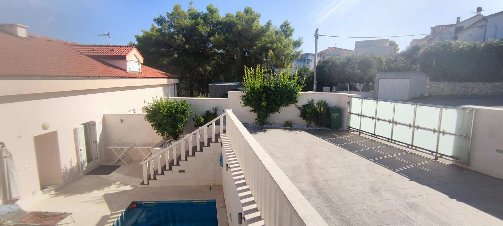 Spacious apartment in Okrug Donji with private terrace and pool view.