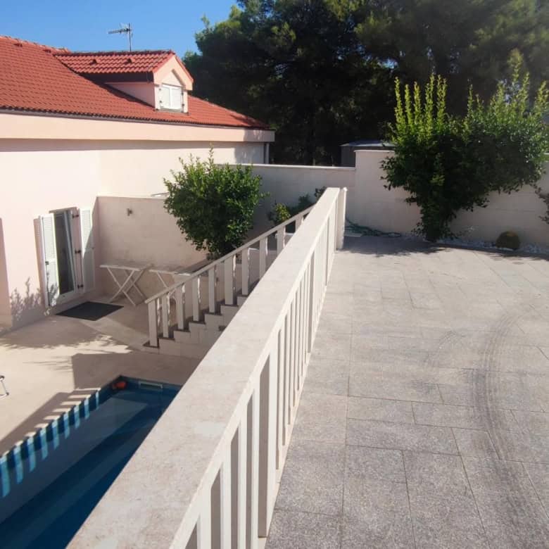 Spacious terrace with pool and outdoor seating in Okrug Donji Croatia.