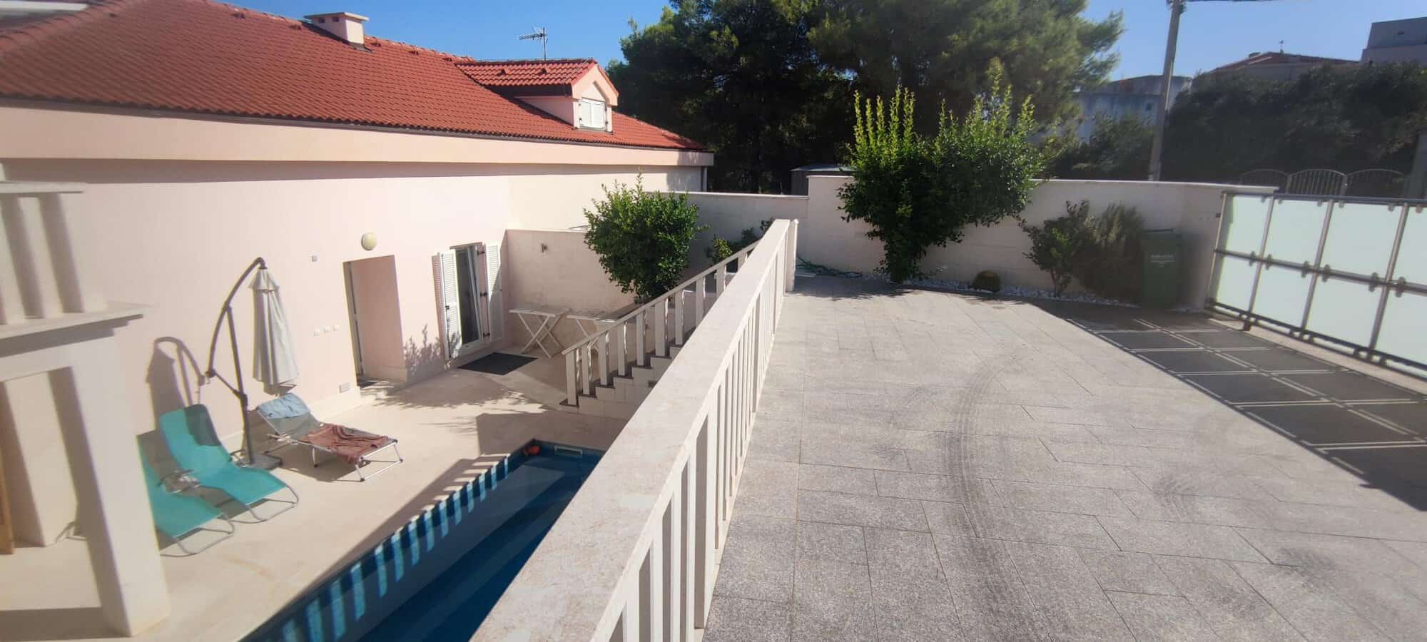 Spacious terrace with pool and outdoor seating in Okrug Donji Croatia.