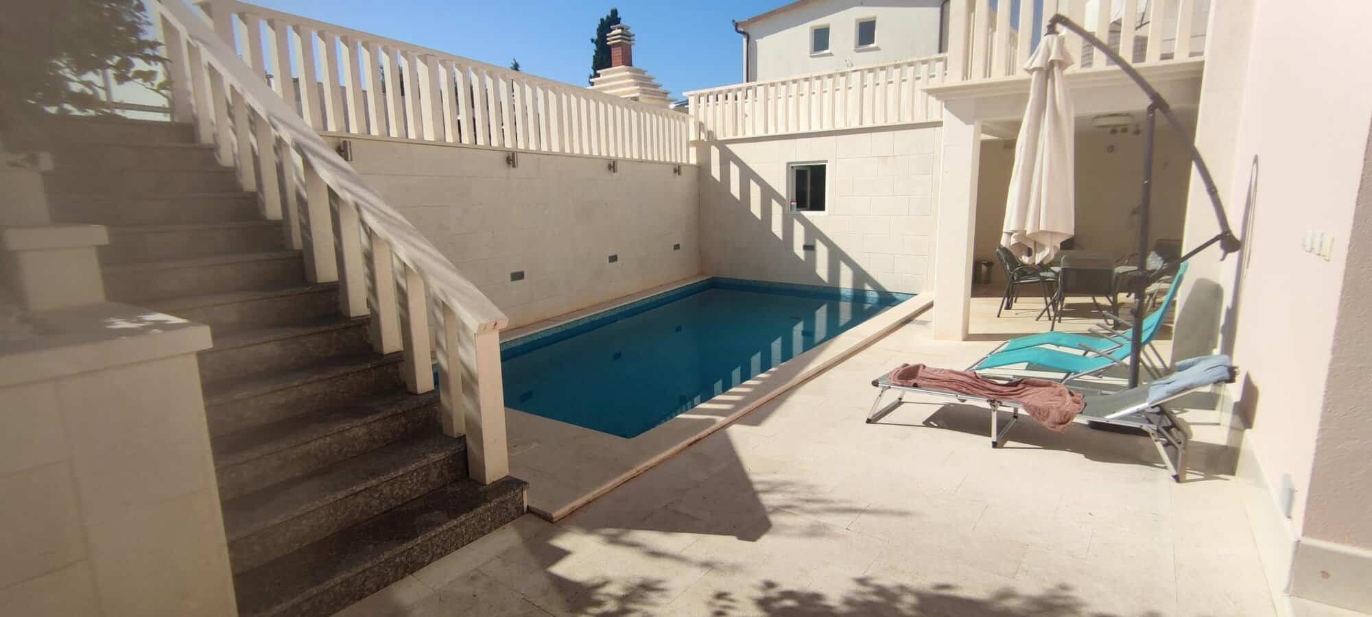 Private pool and terrace of a single apartment in a small complex in Okrug Donji Croatia.