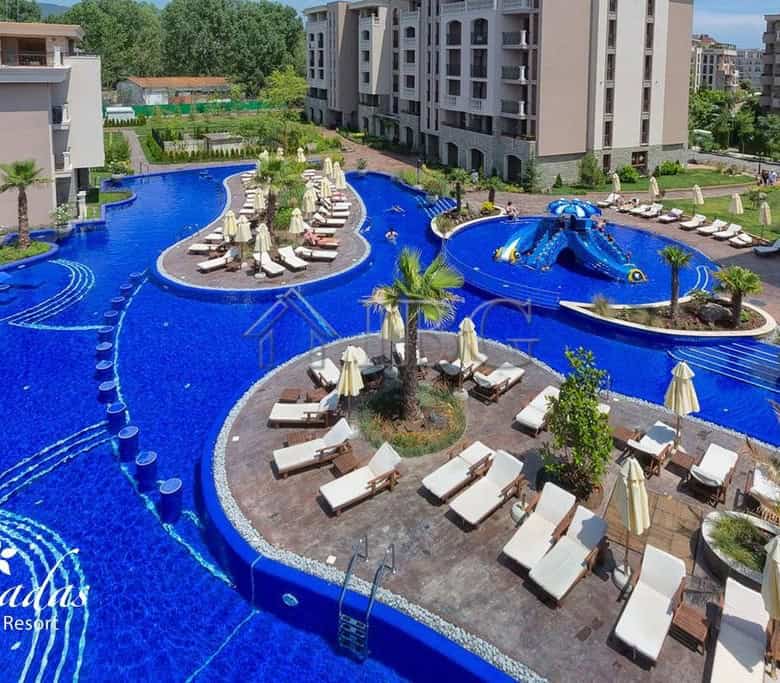 Pool with sun loungers and umbrellas at Cascadas Family Resort, Sunny Beach.