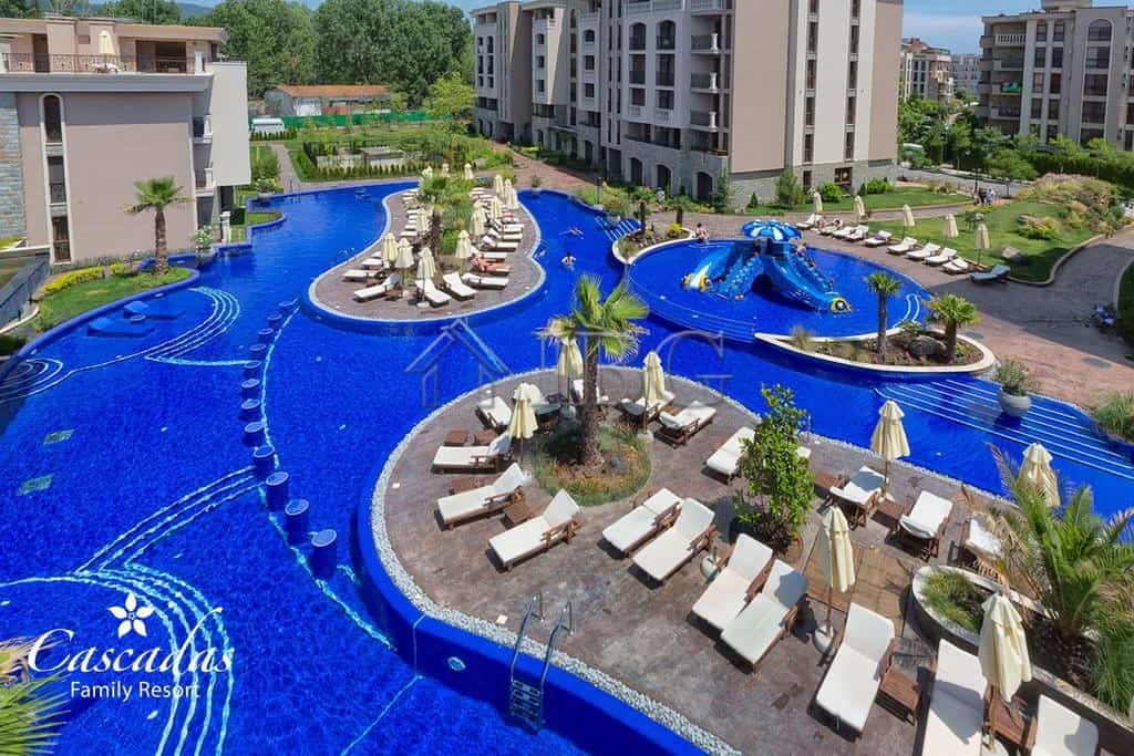 Pool with sun loungers and umbrellas at Cascadas Family Resort, Sunny Beach.