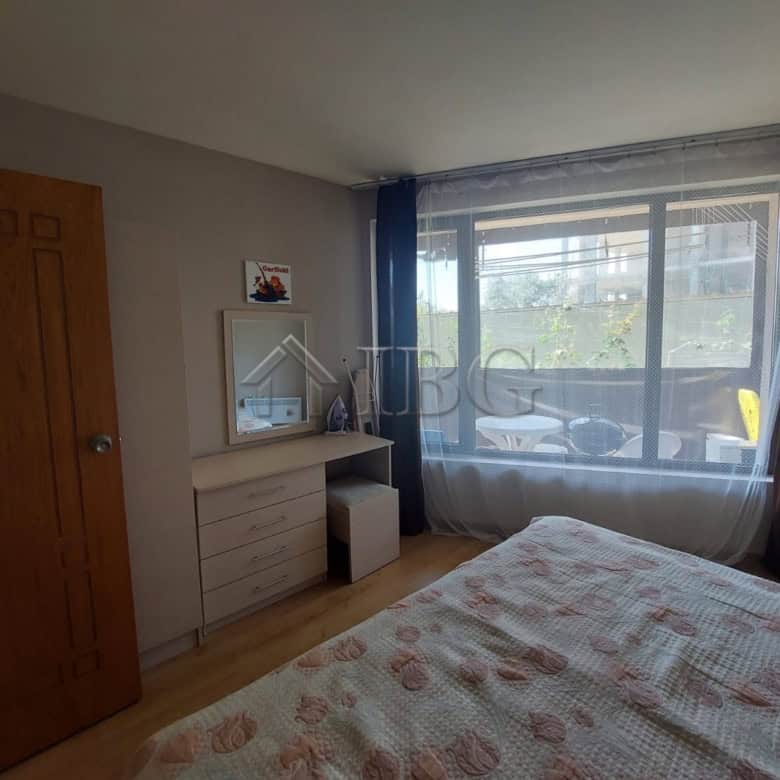 Interior view of a one-bedroom apartment in Sea Grace Complex, Sunny Beach, with a large window and.