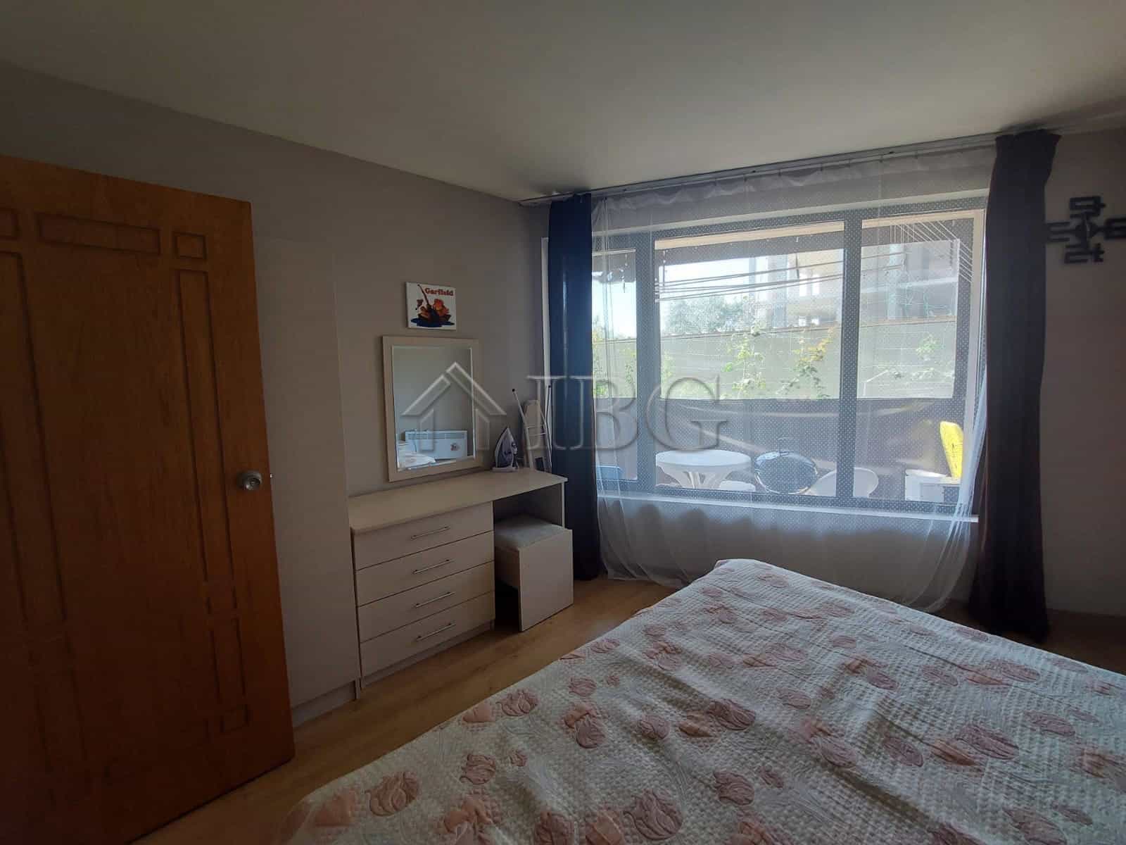 Interior view of a one-bedroom apartment in Sea Grace Complex, Sunny Beach, with a large window and.