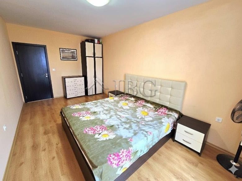 Bright bedroom with a pool view in Sunny Beach apartment.