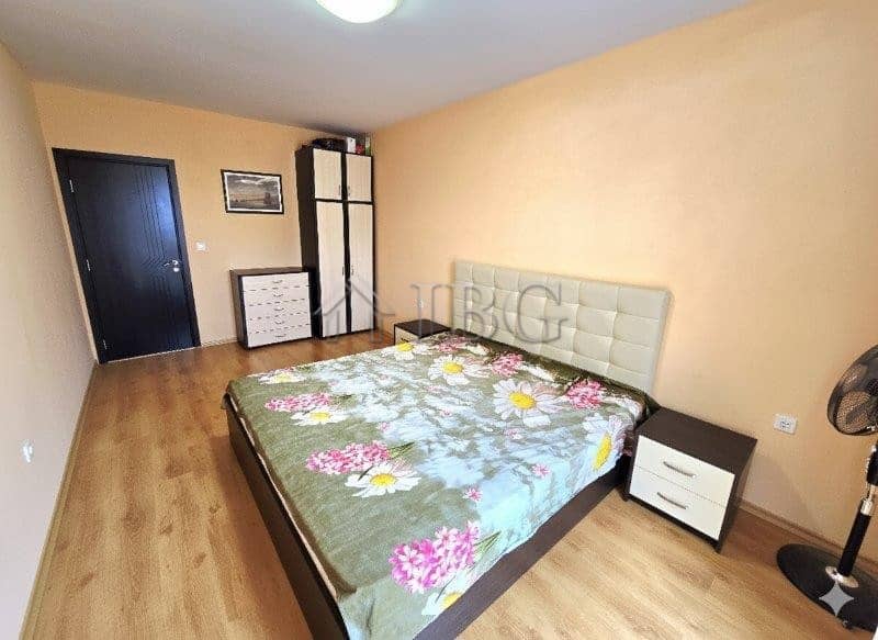 Bright bedroom with a pool view in Sunny Beach apartment.