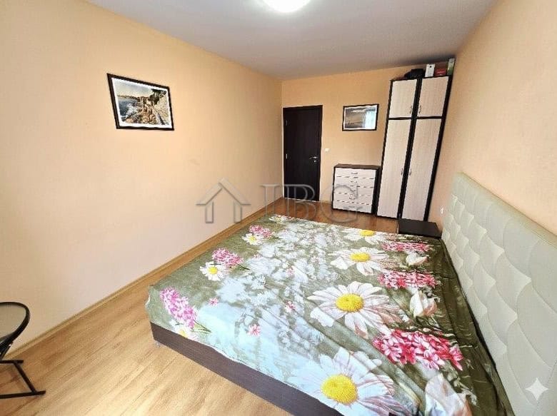 Apartment with pool view and floral bedding in Sunny Beach.