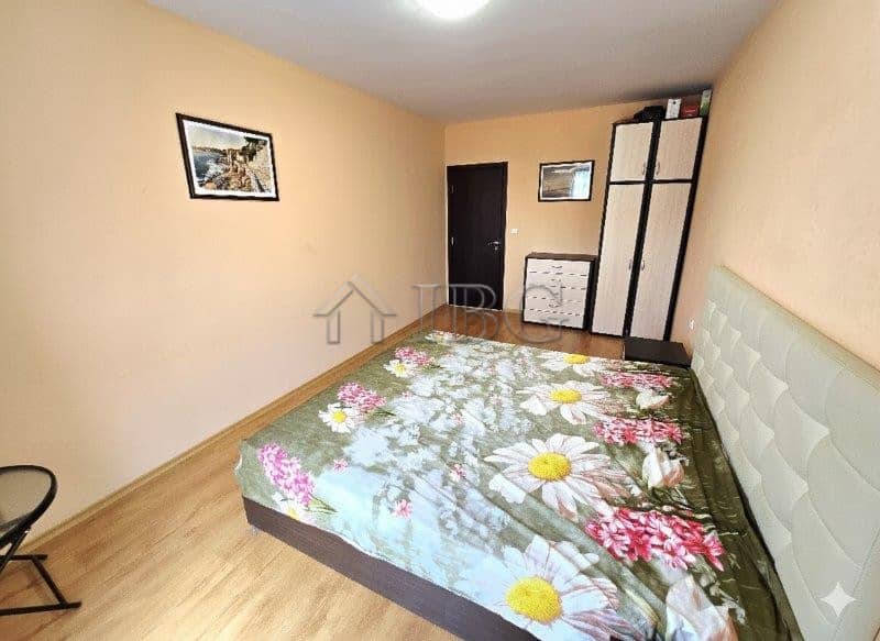 Apartment with pool view and floral bedding in Sunny Beach.