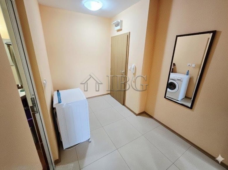 Bright 1-bedroom apartment with pool view, modern decor, and laundry area in Sunny Beach.