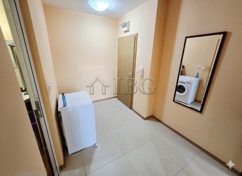 Bright 1-bedroom apartment with pool view, modern decor, and laundry area in Sunny Beach.