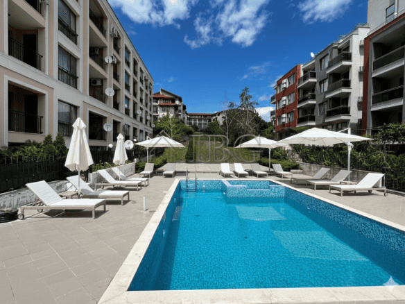 Bright outdoor pool area at Villa Yurta with sun loungers and umbrellas in Sveti Vlas.