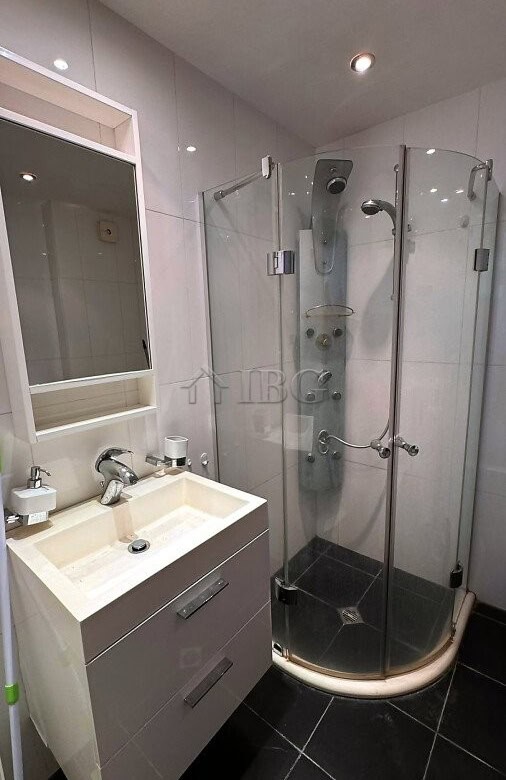 Compact bathroom featuring a glass shower cabin and modern sink in Sveti Vlas apartment.