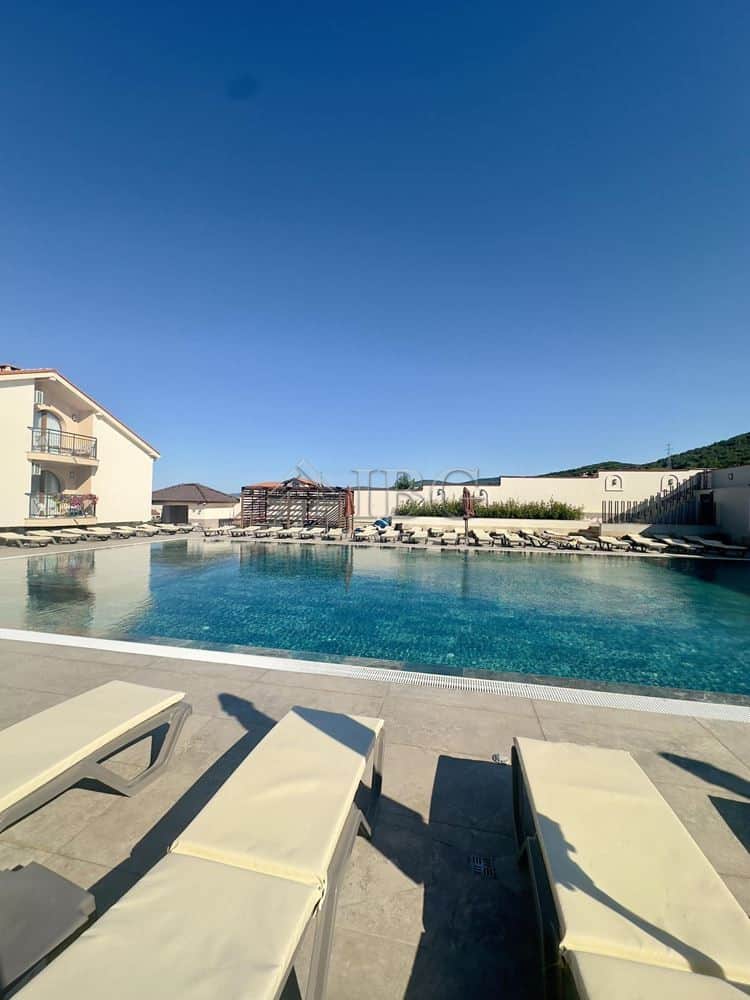 Poolside view of the large swimming pool and sun loungers in the Grand Village complex, Kosharitsa.