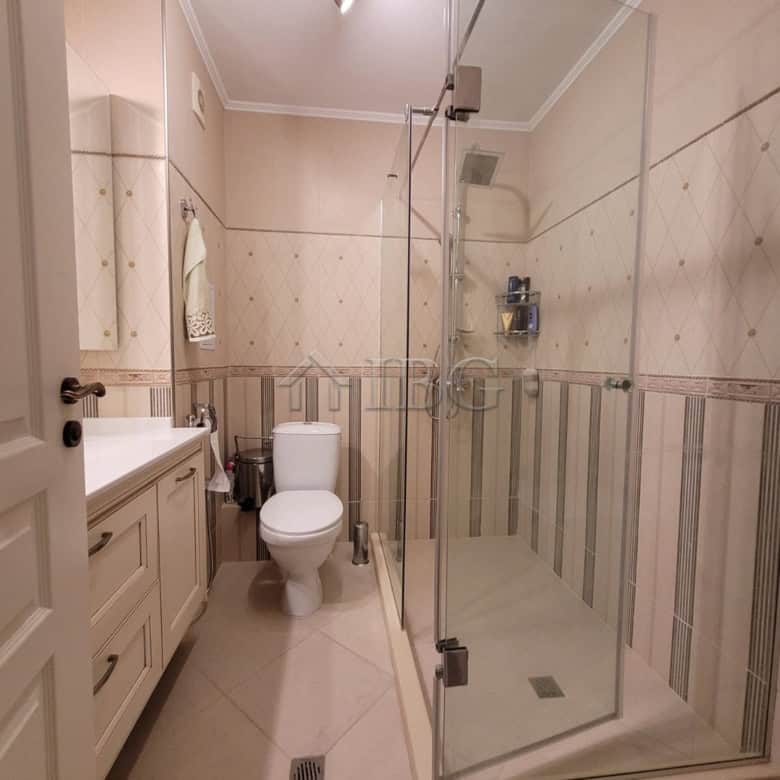 Elegant bathroom in a three-level maisonette featuring a modern shower enclosure and sea view.