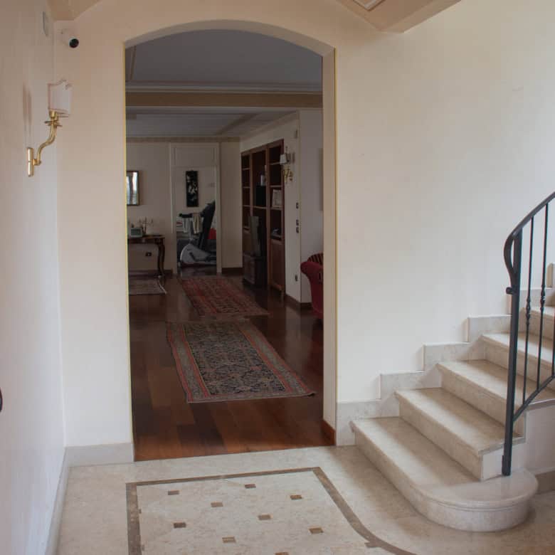 Modern home interior with staircase and living area for sale.
