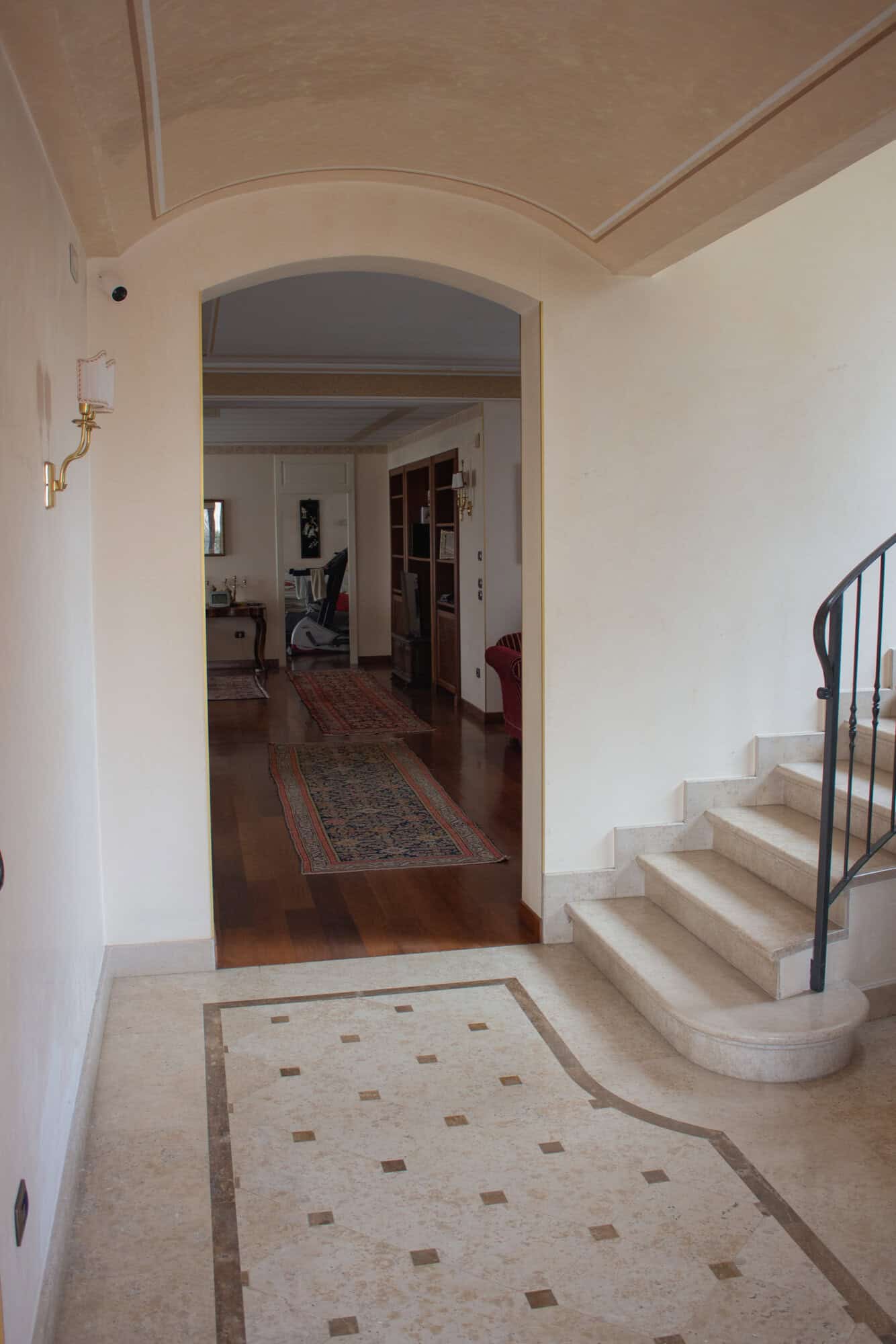Modern home interior with staircase and living area for sale.