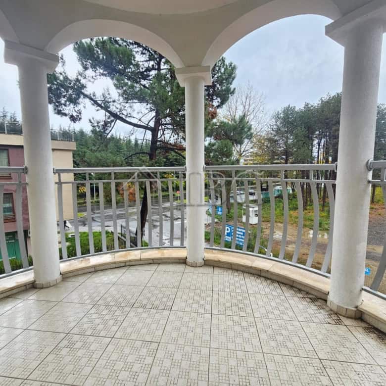 Balcony overlooking lush garden and trees, perfect for relaxing outdoors.