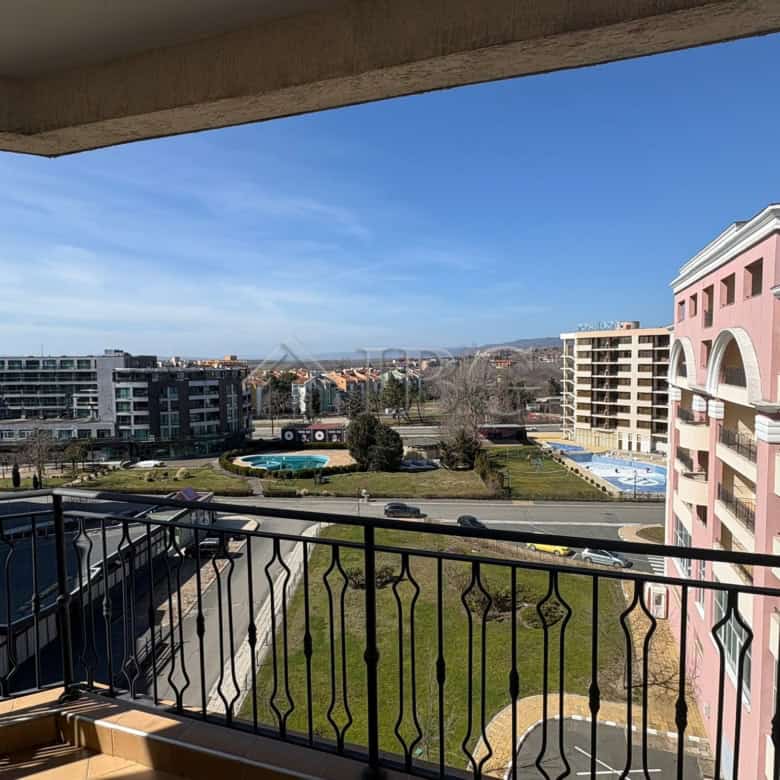 Balcony view of Sunny Beach cityscape with modern buildings and green spaces.