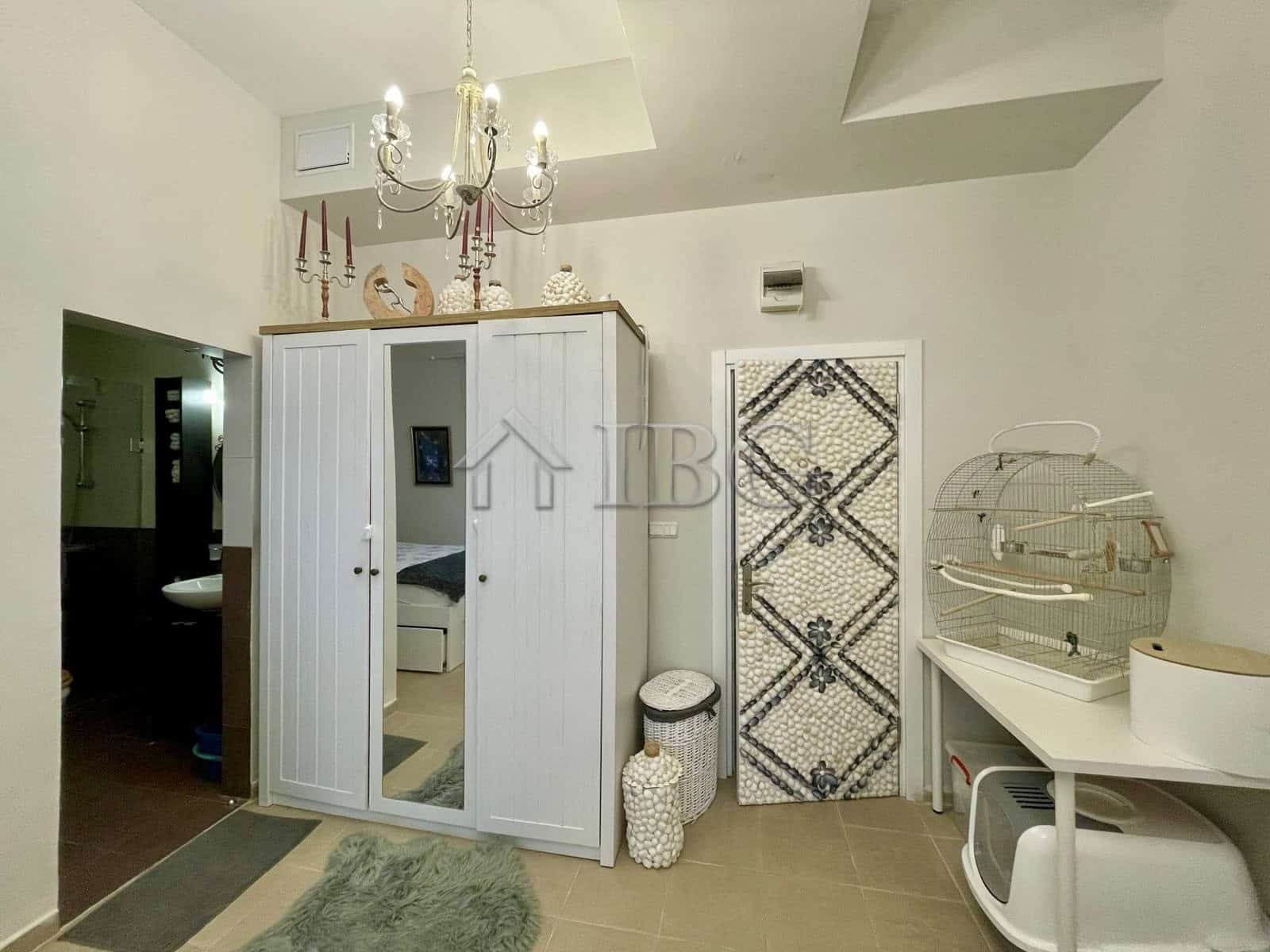 Bright bedroom featuring a large wardrobe and decorative elements in Sun Gate, Sunny Beach.