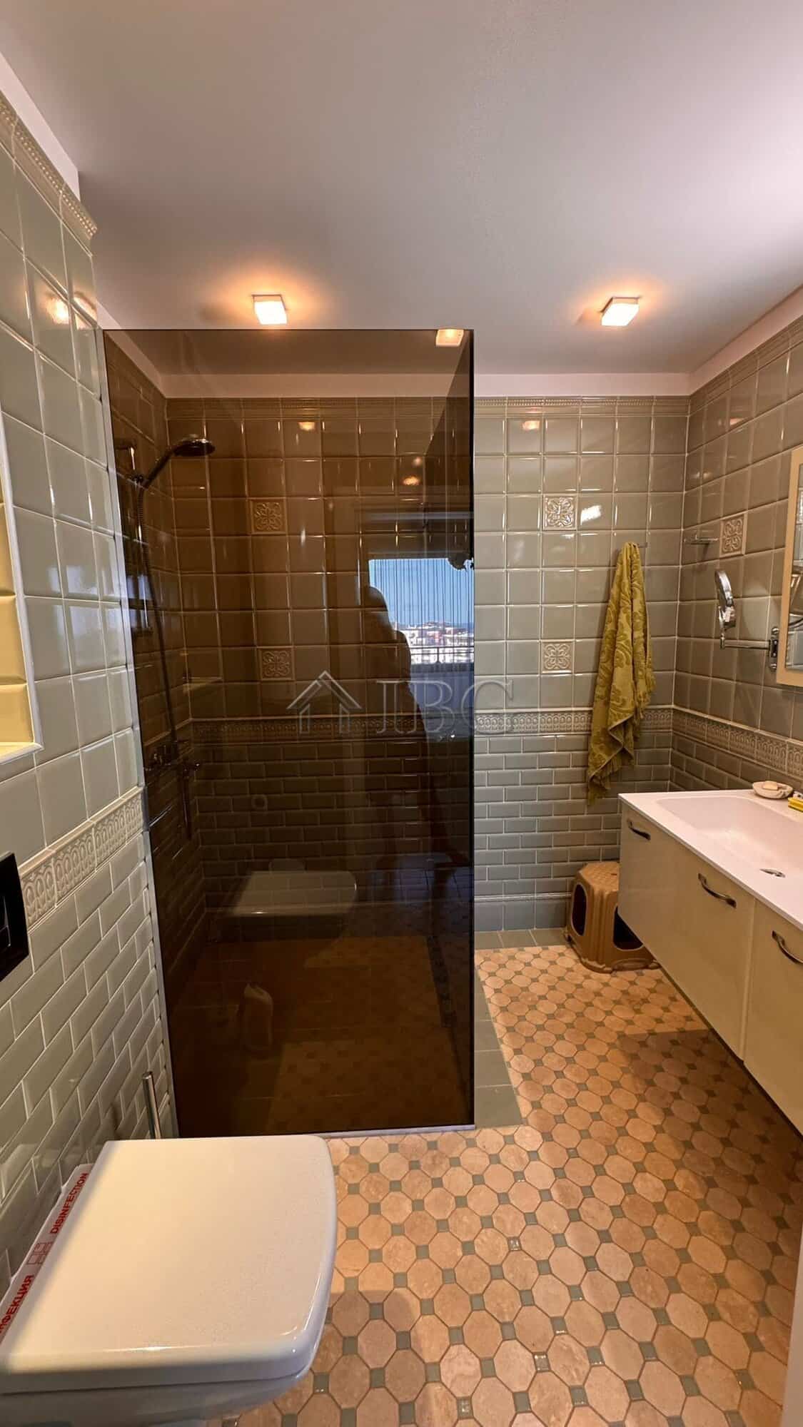 Bathroom with glass shower enclosure and sea view in Sveti Vlas.