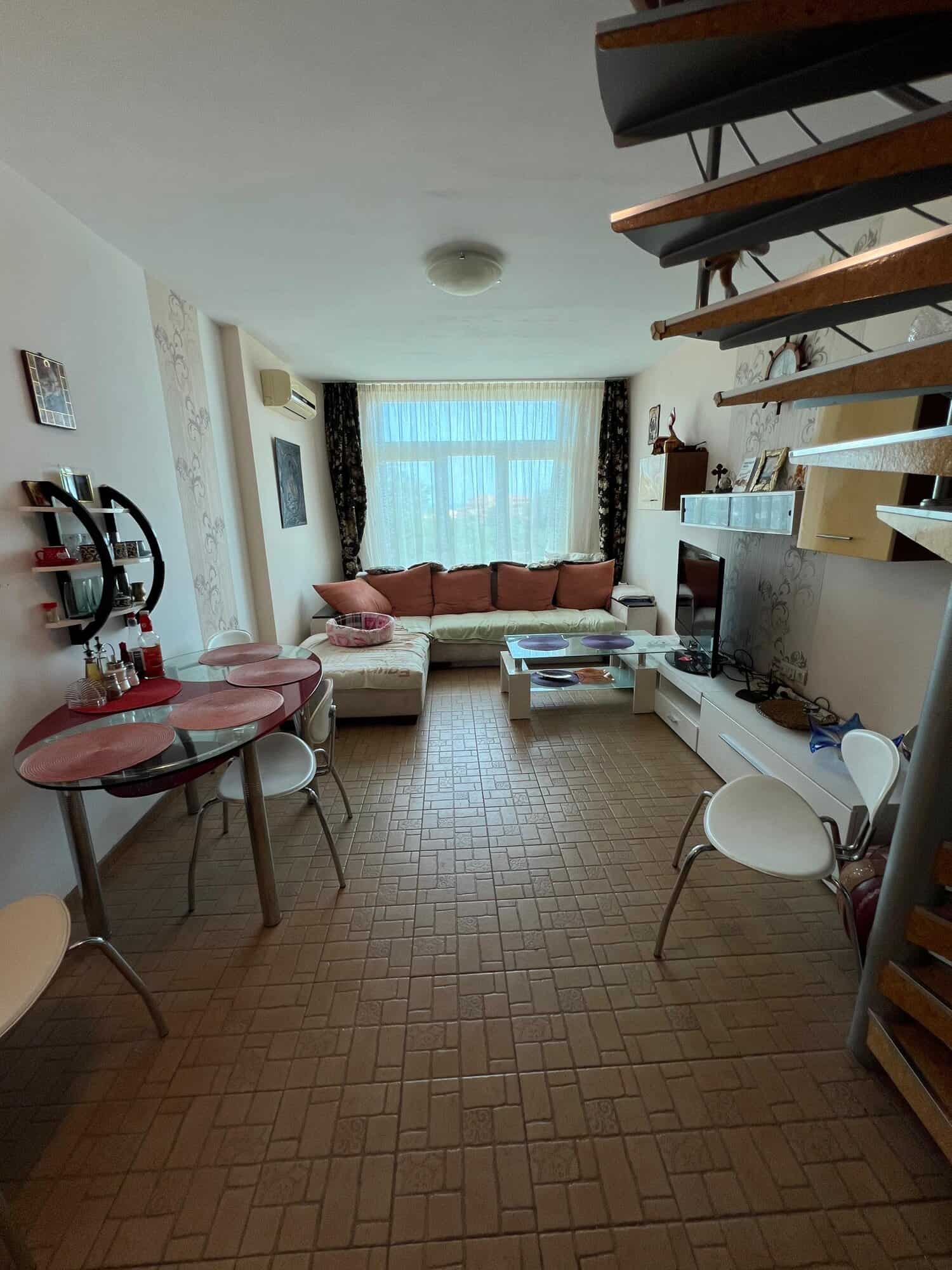 Bright interior of a one-bedroom maisonette with partial sea view in Sunny Beach. Modern furnishings.