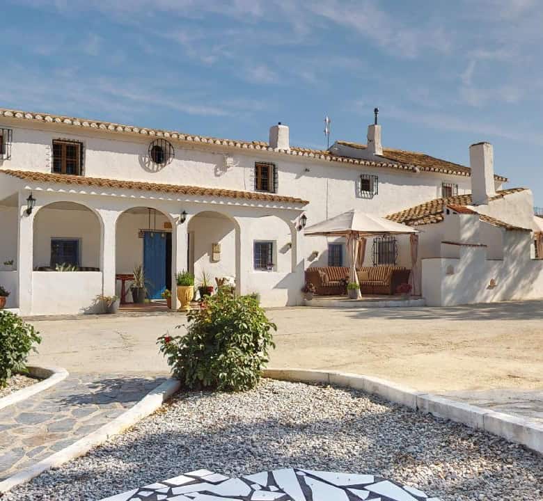 Elegant boutique hotel with traditional Spanish architecture in Caniles, Granada, offering a unique.