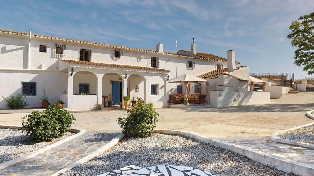 Elegant boutique hotel with traditional Spanish architecture in Caniles, Granada, offering a unique.