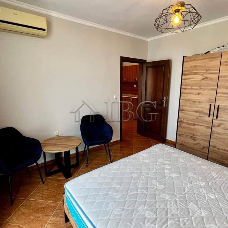 Spacious bedroom with wardrobe, seating area, and modern decor in Helios Complex, Sveti Vlas.