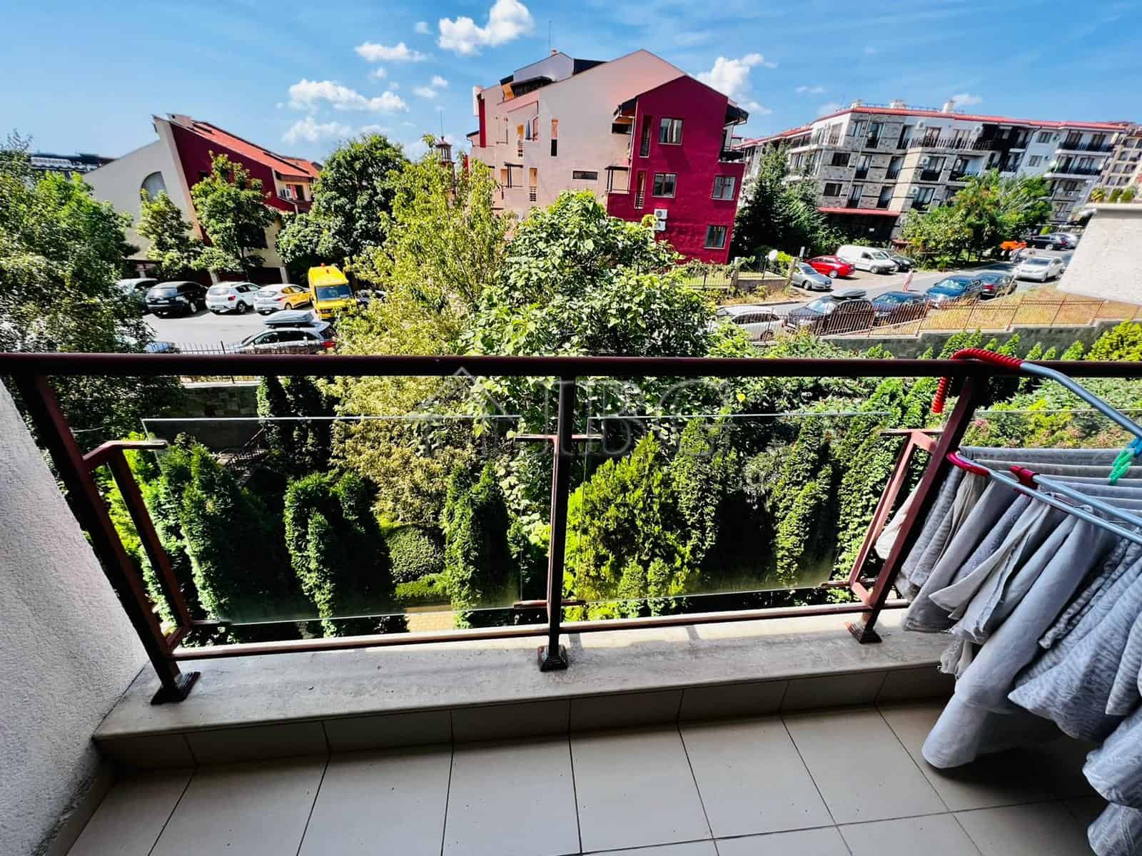 Balcony view of Sveti Vlas with colorful buildings and lush greenery.