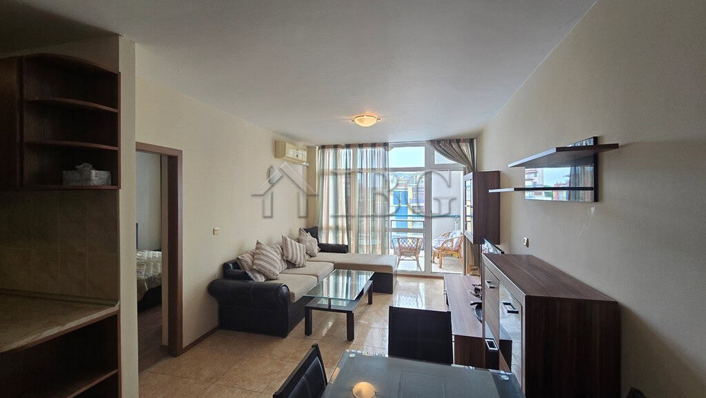 Spacious living room with sofa, coffee table, and balcony view in Sunny Beach. Perfect for relaxing.
