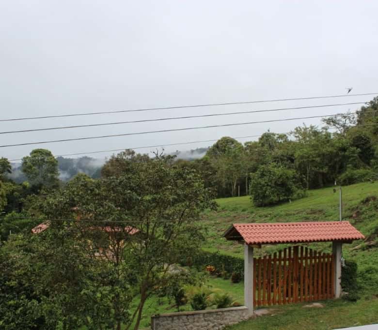 Spacious 5-bedroom house for sale in Portal de Mindo, Ecuador, surrounded by lush greenery and sceni.
