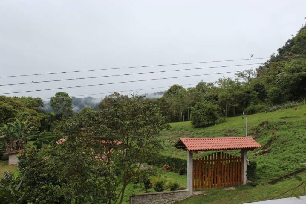 Spacious 5-bedroom house for sale in Portal de Mindo, Ecuador, surrounded by lush greenery and sceni.
