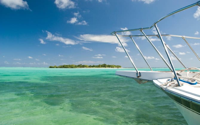 Two land plots for sale on Little Cayman, Cayman Islands with turquoise waters.