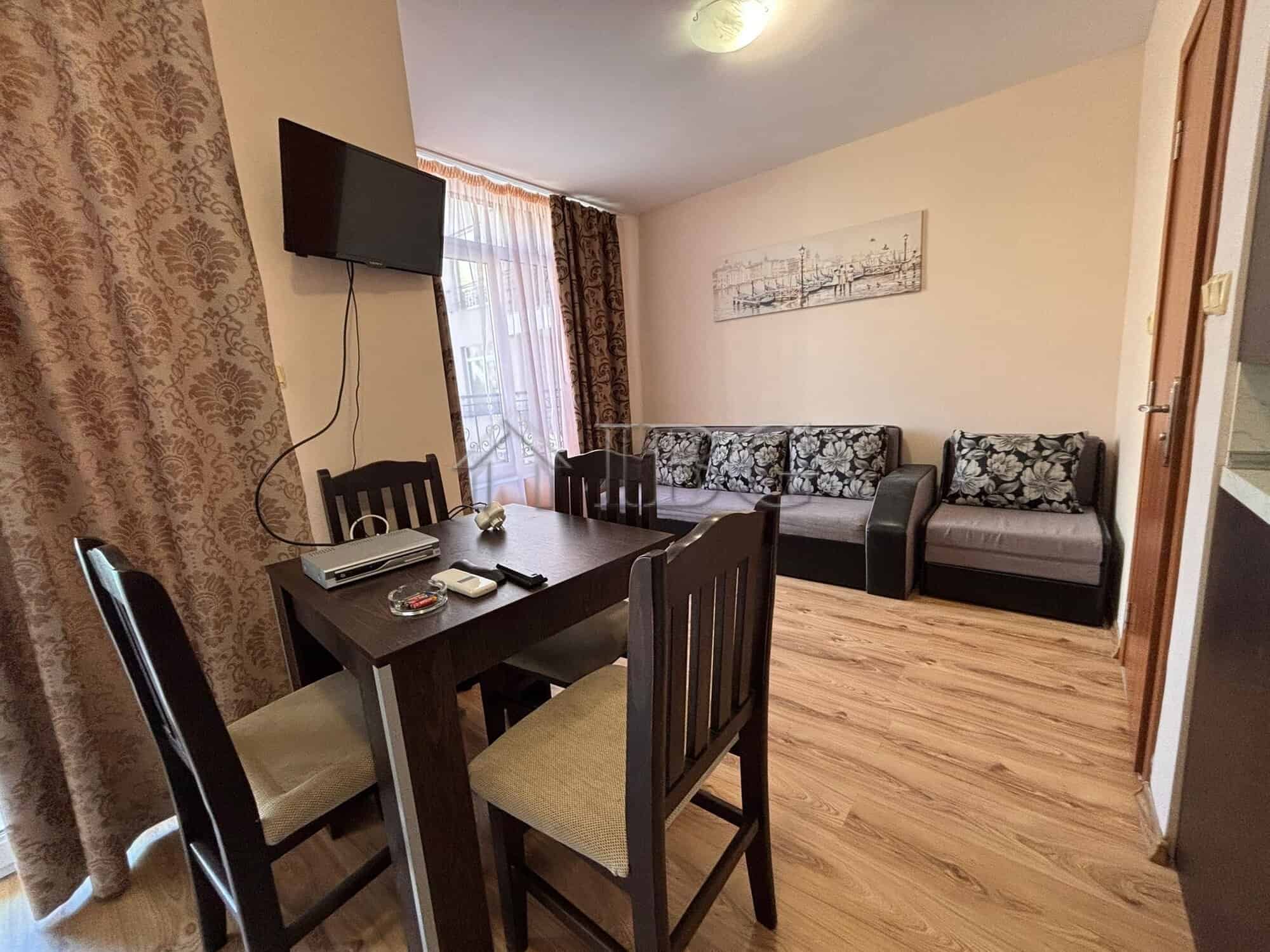 Bright living room with modern furnishings and a flat-screen TV.