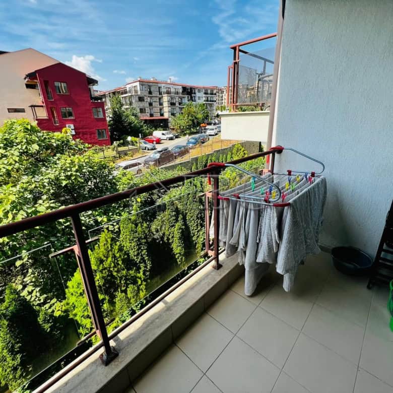 Balcony view of Sveti Vlas with lush greenery and colorful buildings, perfect for relaxing outdoor m.