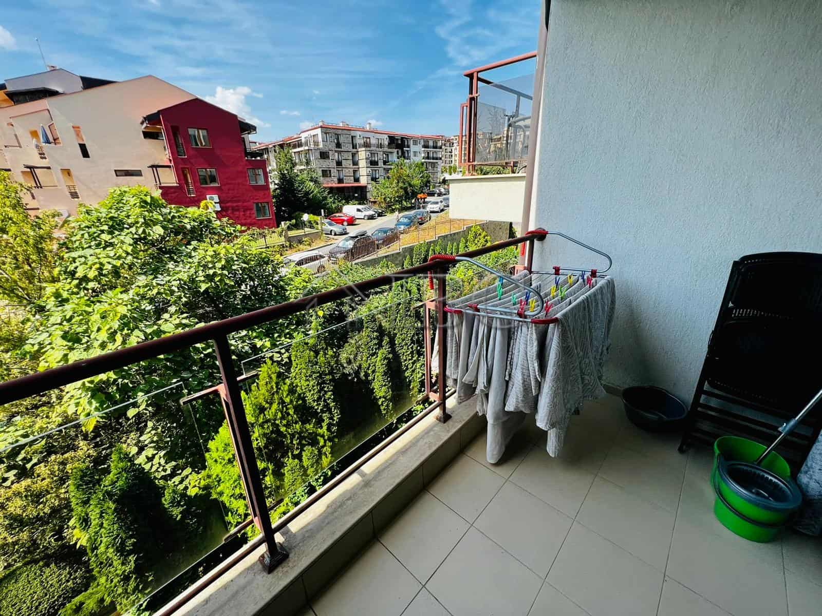Balcony view of Sveti Vlas with lush greenery and colorful buildings, perfect for relaxing outdoor m.