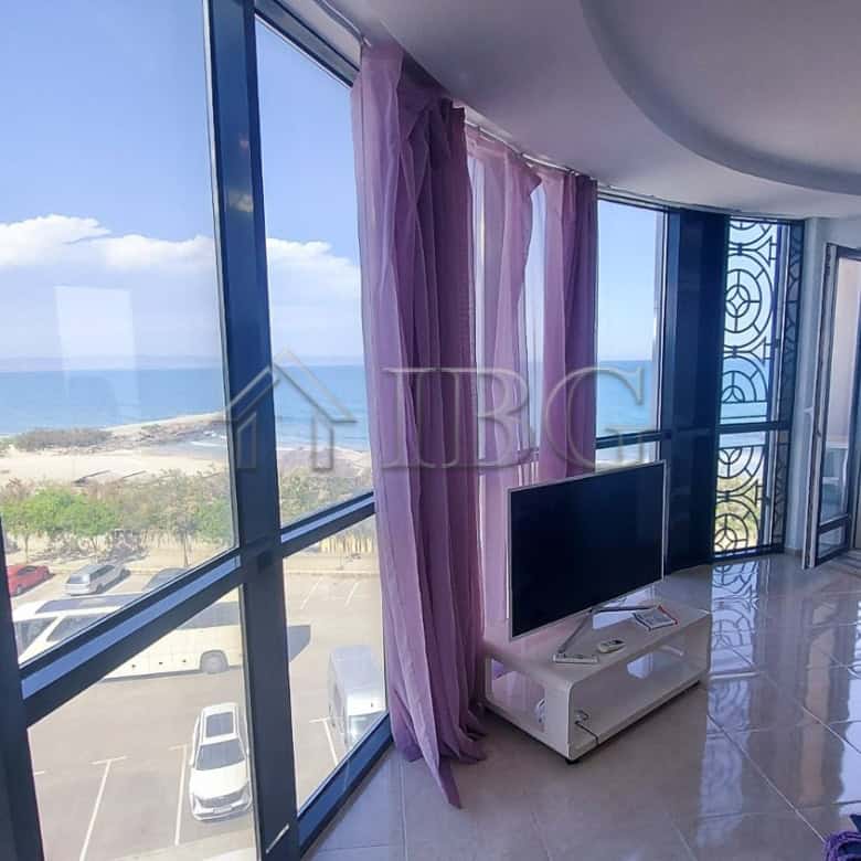 Bright living room with panoramic sea views and large windows.