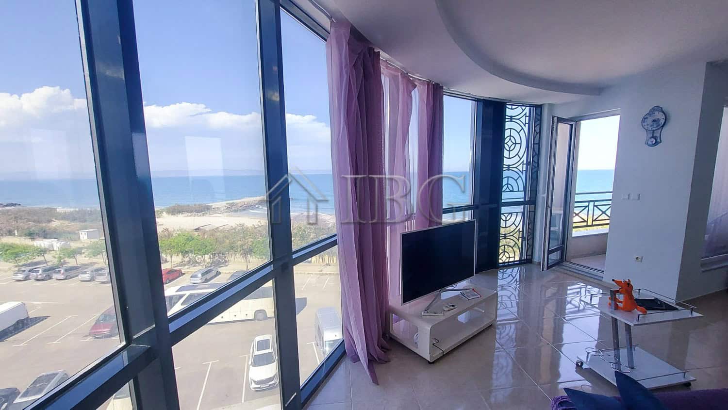 Bright living room with panoramic sea views and large windows.