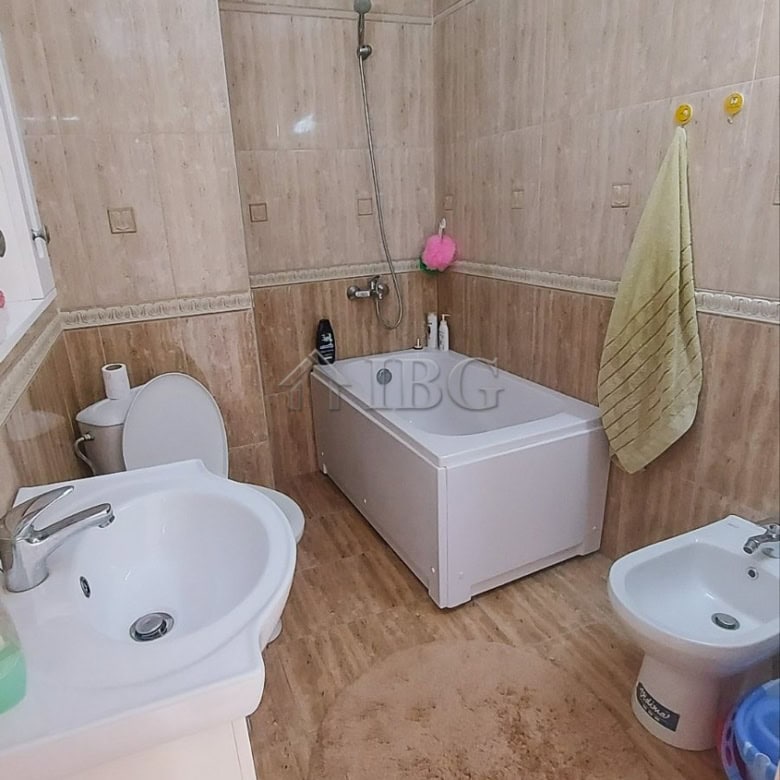 Bright bathroom with bathtub and modern fixtures in a seaside apartment.