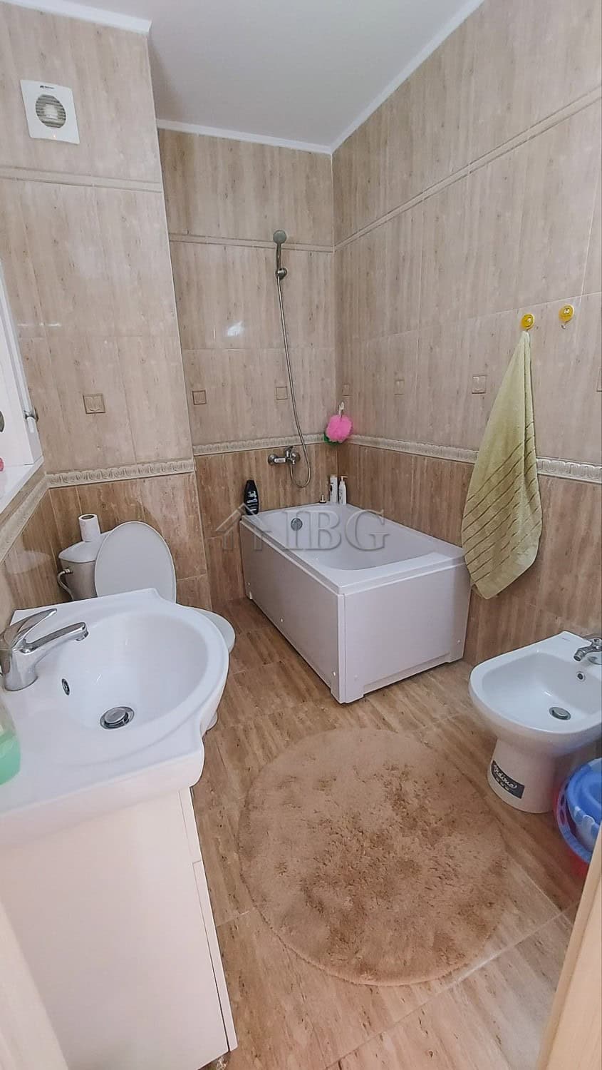 Bright bathroom with bathtub and modern fixtures in a seaside apartment.