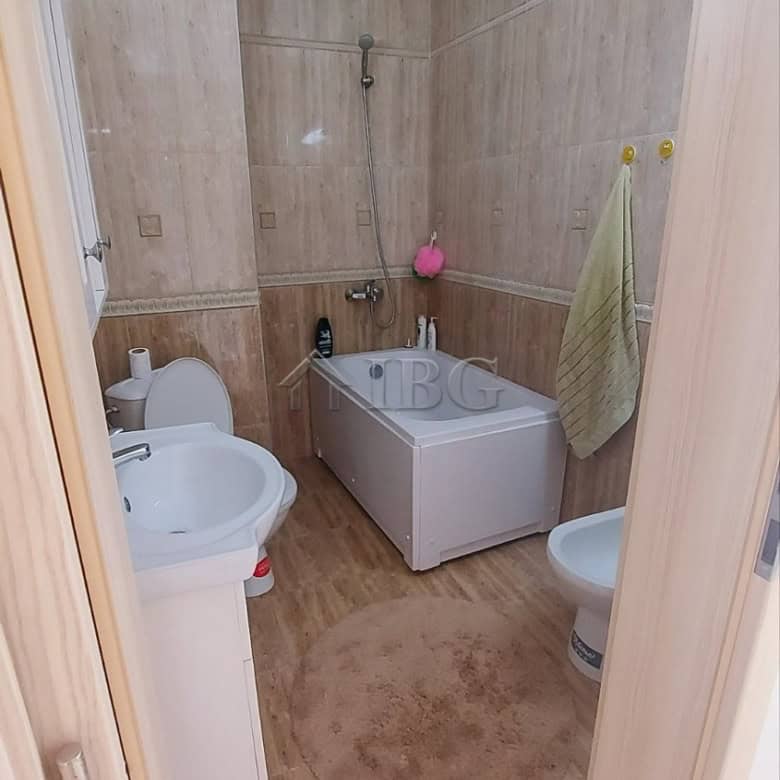 Bathroom with bathtub, toilet, and washing machine in a compact apartment.