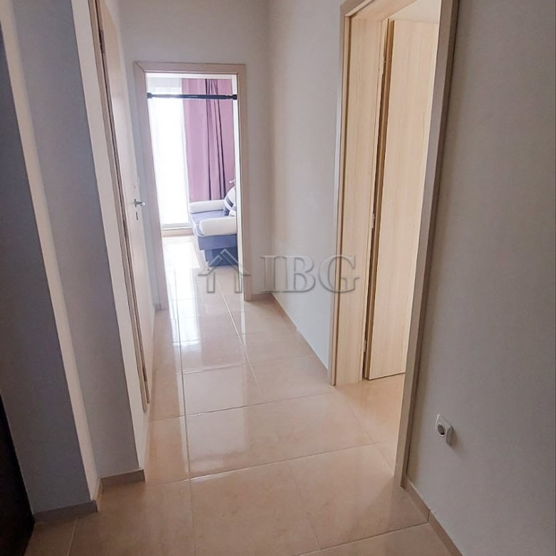 Bright hallway leading to living area with sea view in Pomorie apartment.