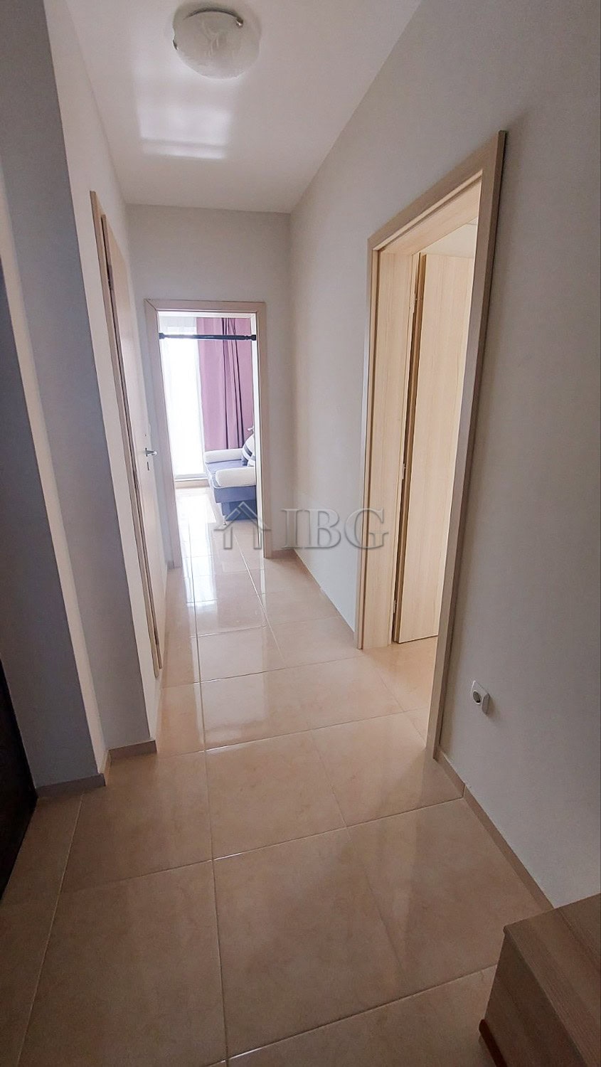 Bright hallway leading to living area with sea view in Pomorie apartment.