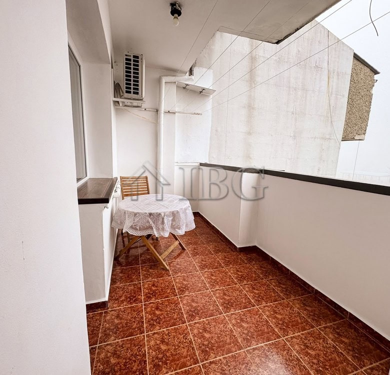 Balcony of a 2-bedroom apartment in Druzhba 2, Ruse, with outdoor seating and city views.