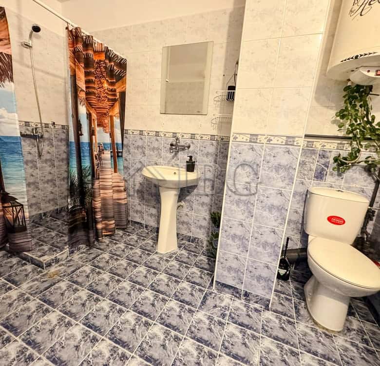 Bright bathroom with shower, sink, and toilet in Druzhba 2, Ruse.