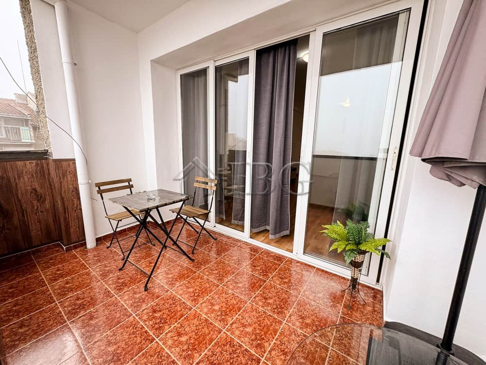 Balcony of a 2-bedroom apartment in Druzhba 2, Ruse, with outdoor furniture and potted plants.