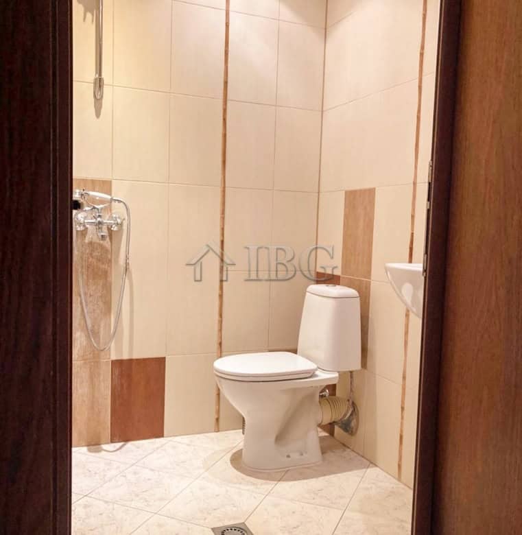 Clean bathroom with toilet and shower in Ruse apartment rental.