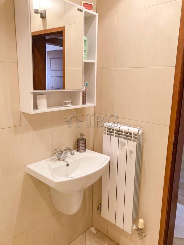Cozy Bathroom in Ruse Apartment Bathroom with sink, mirror, and radiator in Ruse apartment.