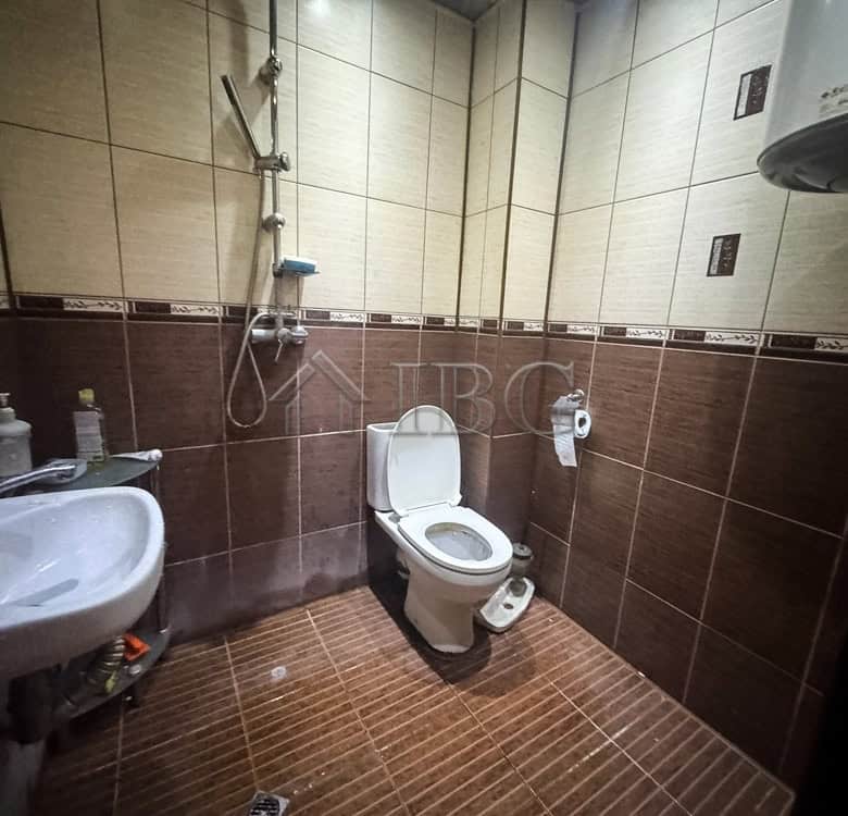 Bathroom with toilet and sink in a central Ruse apartment near Svoboda Square.