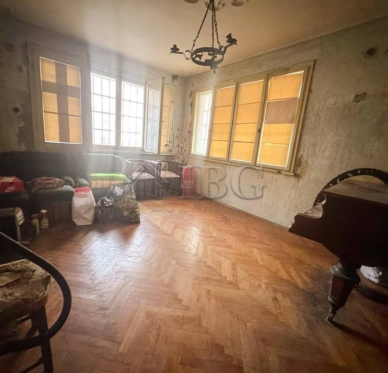 Spacious living room with large windows in a central Ruse location.